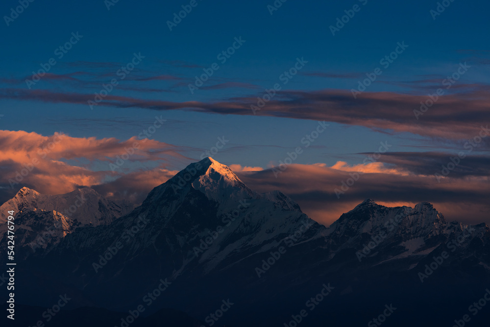 First ray of morning sun on the majestic Kangchenjunga range (third highest in the World) of Himalayas. The highlighted peak is Mt. Siniolchu (6,888 metres) in centre. Photo taken from Sandakphu.