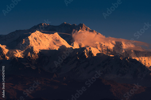 First ray of morning sun on the peaks of majestic Kangchenjunga mountain range (third highest in the World) of Himalayas. Photo taken from Sandakphu, West Bengal. © suprabhat