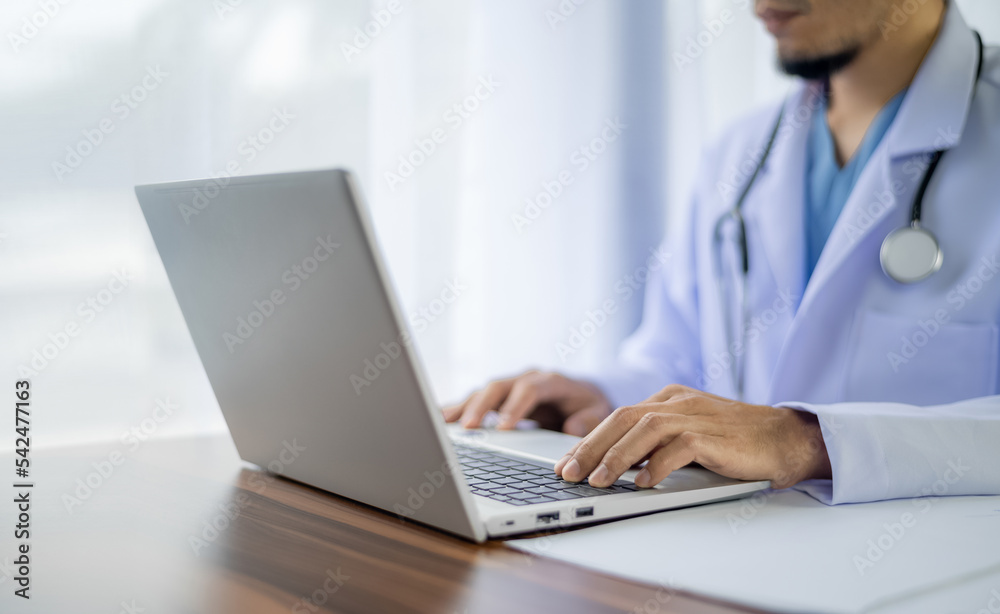 Doctor using computer working in hospital, Doctor using computer checking data patient document, Doctor using computer for health care hospital background Doctor using computer working in hospital, Doctor using computer checking data patient document, Doctor using computer for health care hospital background