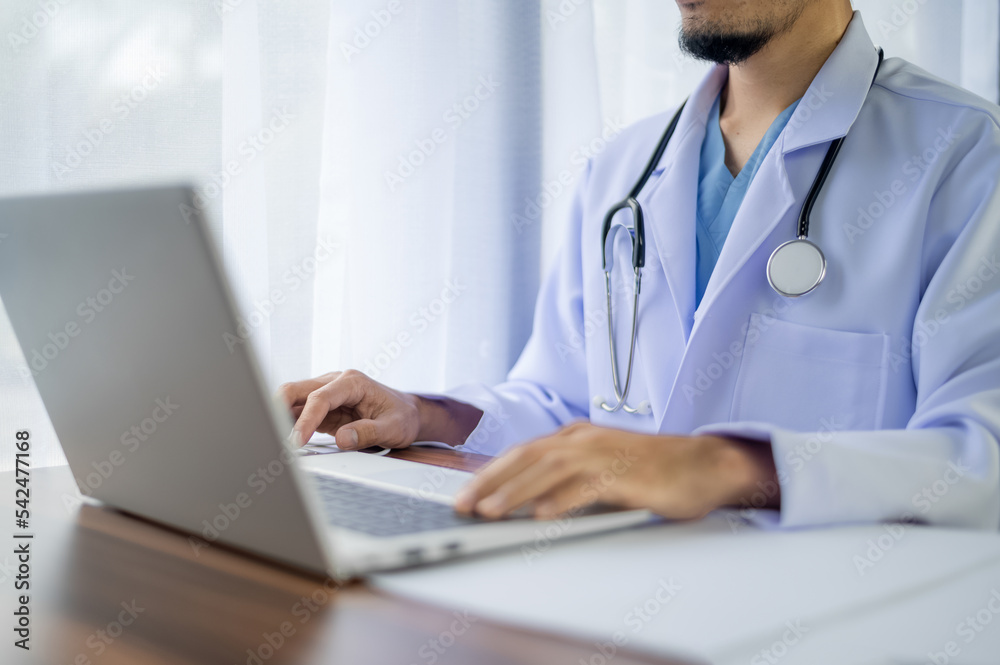 Doctor using computer working in hospital, Doctor using computer checking data patient document, Doctor using computer for health care hospital background Doctor using computer working in hospital, Doctor using computer checking data patient document, Doctor using computer for health care hospital background