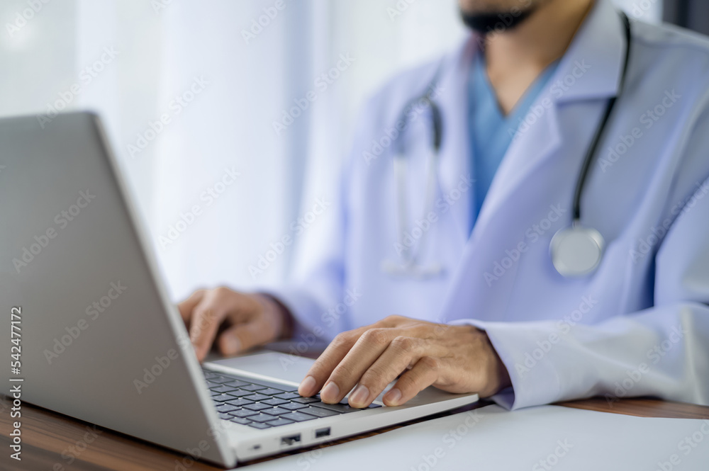 Doctor using computer working in hospital, Doctor using computer checking data patient document, Doctor using computer for health care hospital background Doctor using computer working in hospital, Doctor using computer checking data patient document, Doctor using computer for health care hospital background