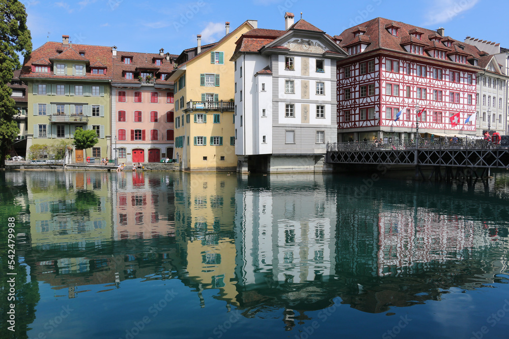 Water reflections of townhouses in the river (Lucerne, Switzerland)