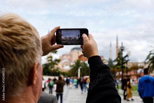 Adult man taking a picture of a islamic city © Andrey Cherkasov
