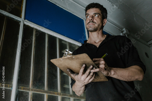 Technician checking paperwork in car service station