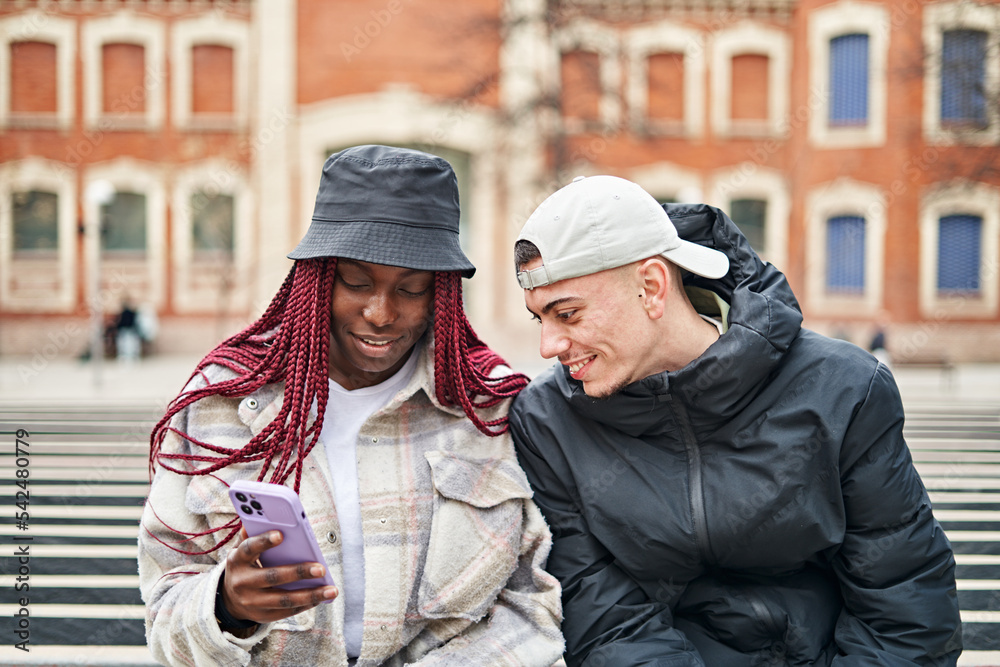 Portrait of a multi-ethnic couple using the phone, in the street