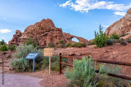Moab, Utah Canyons at Arches National Park with Skyline Arch in background and information sign at trailhead trail hike with nobody