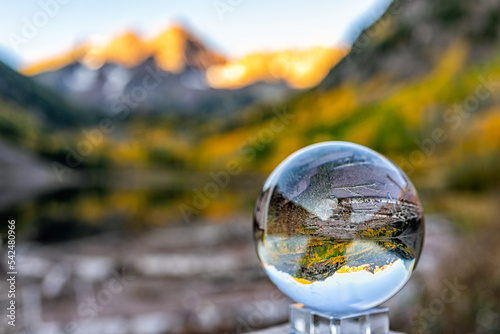 Maroon Bells lake at sunrise with crystal ball glass reflection in Aspen, Colorado with rocky mountain peak and snow in October autumn fall leaf color season © Kristina Blokhin