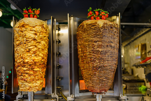 Grilled chicken meat on a vertical rotisserie used in traditional turkish street food Doner Kebab (Shawarma or Gyros in other cultures) in Istanbul, Turkey