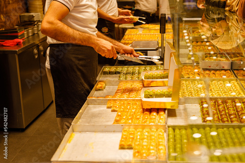 Traditional Turkish dessert Baklava, close-up trays of delicious baklava displayed in showcase of baklavalari shop