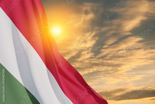 Waving flag of Hungary in sunset sky. Independence day, National day. Background with place for your text. 3d-rendering. photo