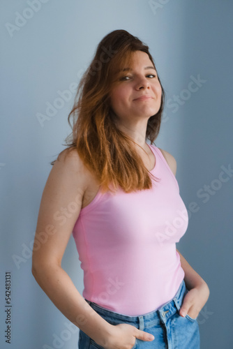 candid portrait of a happy woman on monochrome background, real female body in casual fashion