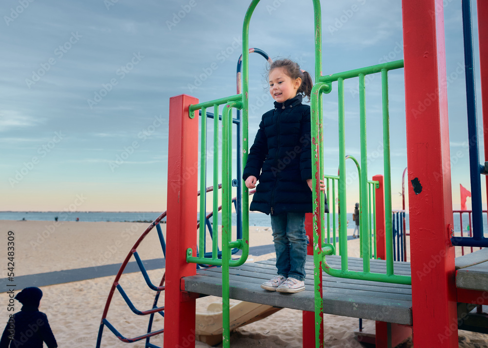 Young girl playing at the beach playground