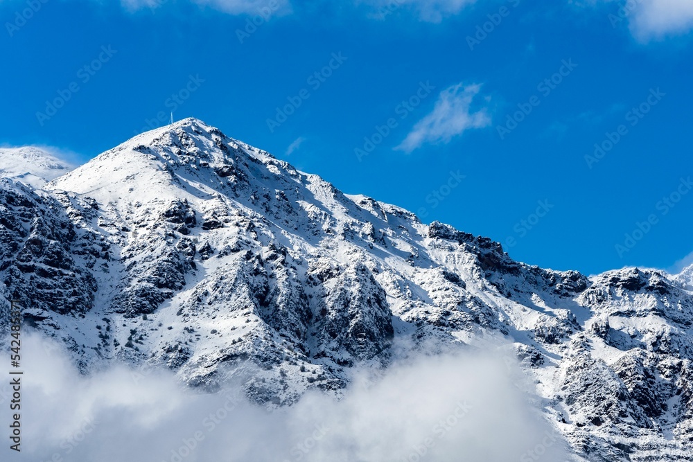 Landscape of snowy mountain under sunny blue sky