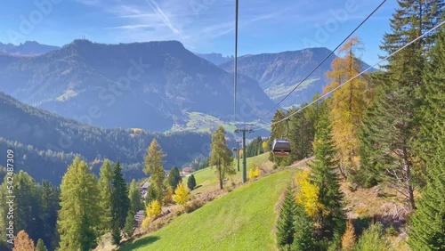 Travel video Seceda ropeway in Dolomites with Autumn Leaves background A wonderful view of Seceda mountains, dolomites, italy, Cable Car moving down the mountain with beautyful view in sunny day