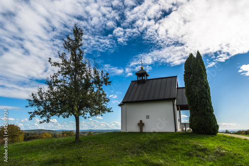 Small chapel on a hill in sunny autumn