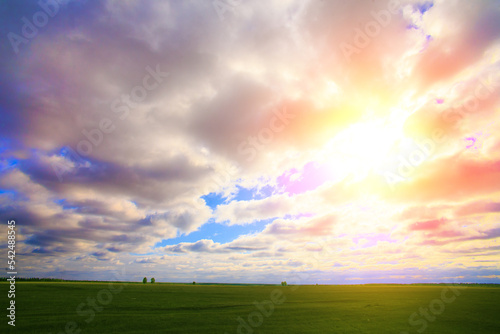 sky with sun and clouds over the field