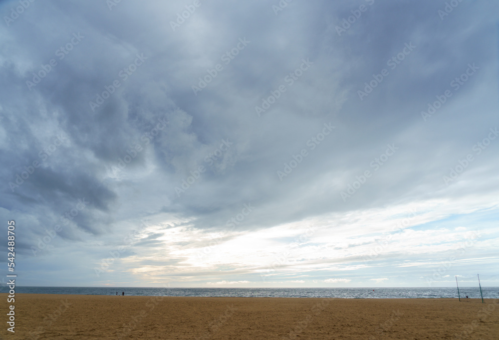 cloudscape with dramatic weather over the beach and ocean