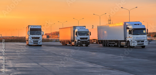 Trucks in a parking lot on a suburban highway photo