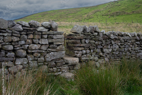 Stone stile on a hiking path in the Yorkshire Dales, England, UK.