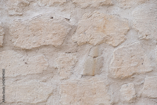 Detailed textured background of sandstone old wall with blocks light yellow colored texture