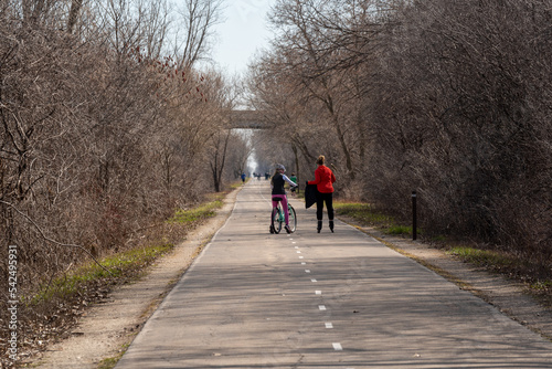 People Enjoying The Fox River Trail In Spring In De Pere, Wisconsin