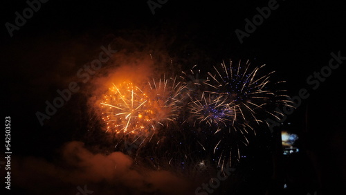 4k. Bright New Year s fireworks 2023. beautiful new year s eve. glowing loop christmas bokeh. holiday day christmas. beautiful bright color spot show. eve New Year s holiday. national festival sky.