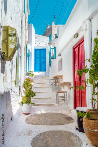 Traditional cycladitic alley with a narrow street and whitewashed houses in Amorgos Greece