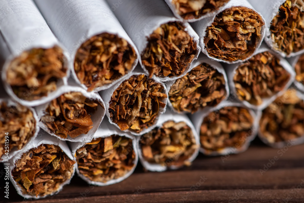 Obraz premium image of several commercially made cigarettes. pile cigarette on wooden. or Non smoking campaign concept, tobacco