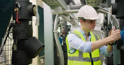 Professional Inspector Engineer foreman in hardhat checking try to open or close turning high pressure valve on pipeline