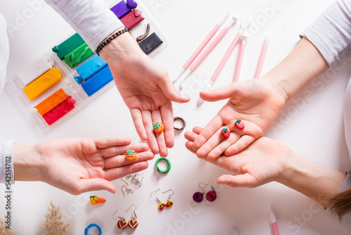 Fotografi Earrings made of polymer clay in children's hands