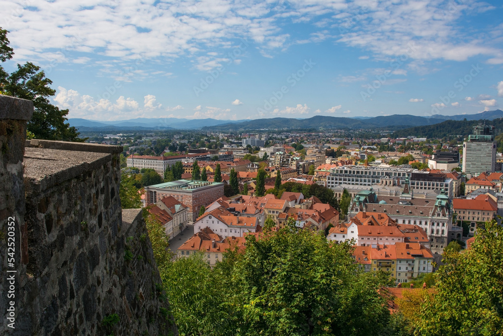 The city of Ljubljana in central Slovenia viewed from the historic castle on Castle Hill. Part of the castle walls can be seen on the left

