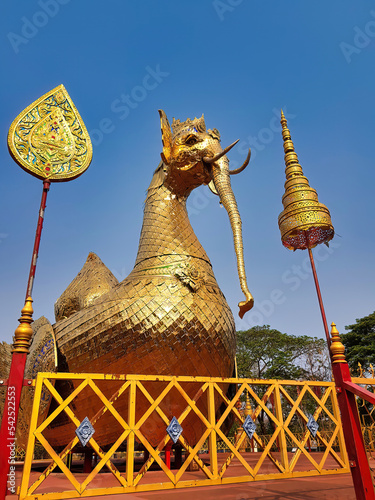 Golden Nok Hatsadiling, a mythical bird with the trunk and tusks of an elephant, in front of the buddhist temple Wat Phra That Su Thon in Phrae, Northern Thailand
 photo