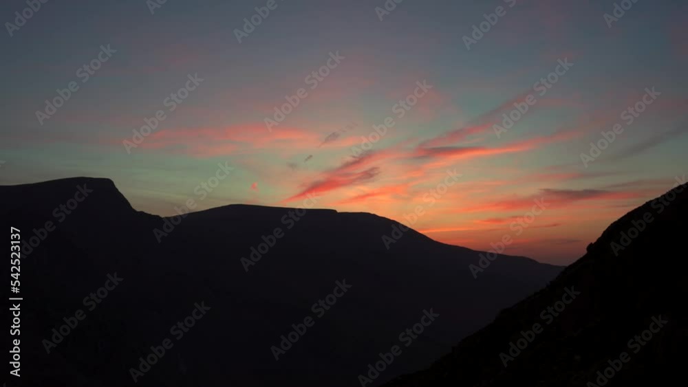 Dark mountain scene with red morning sunrise clouds Dark mountain scene with red morning sunrise clouds