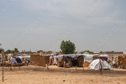 Refugee camp in Africa, full of people who took refuge due to insecurity and armed conflict. People living in very poor conditions, lack of food, clean water and proper shelter to stay in photo