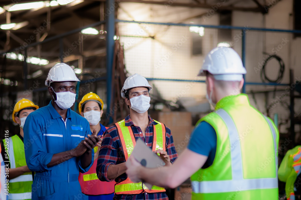 Group of diversity technician, foreman and engineer are happy and standing ovation to congratulate companies that still working and pay wages to employees employees during covid-19 outbreak. Group of diversity technician, foreman and engineer are happy and standing ovation to congratulate companies that still working and pay wages to employees employees during covid-19 outbreak.