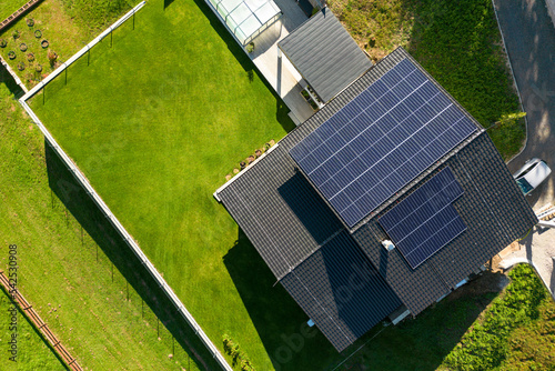 Top view of solar photovoltaic panels on roof, alternative energy, saving resources and sustainable lifestyle concept. photo