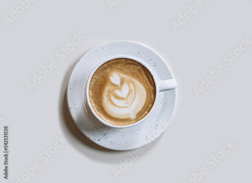 Cup of coffee latte on light background platinum shade. Morning breakfast concept or time spent in pleasure. Close-up