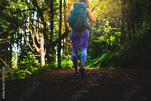 Beautiful woman walking through idyllic beautiful forest in the afternoon. Levada of Caldeirão Verde, Madeira Island, Portugal, Europe.