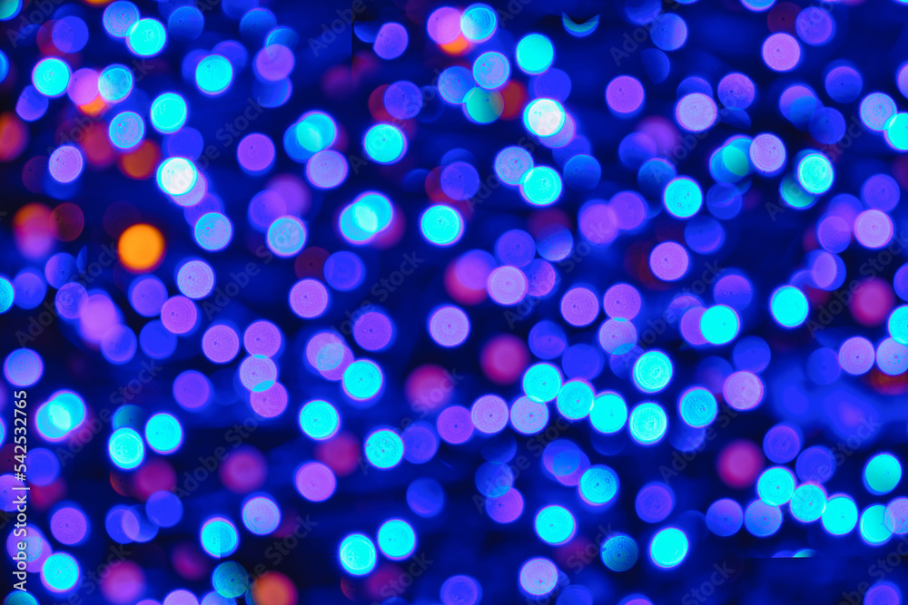 Christmas background with bokeh of colored lights.
