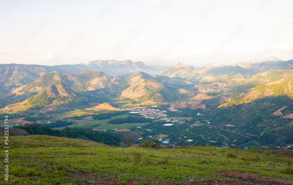 Naklejka premium Small village in the middle of a valley, with green mountains in the background. Landscape of the mountains of Espírito Santo State, Brazil