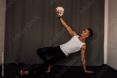 A white skull in the hands of a man. Anatomy