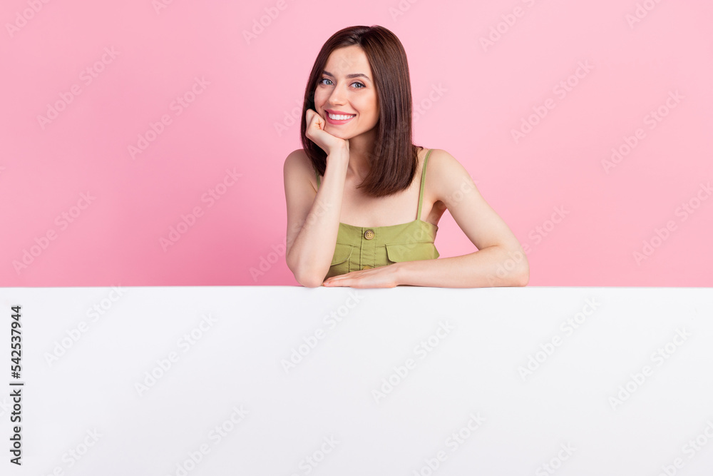 Photo of positive lovely cute lady arm touch face show bright smile present empty space isolated on pink color background Photo of positive lovely cute lady arm touch face show bright smile present empty space isolated on pink color background