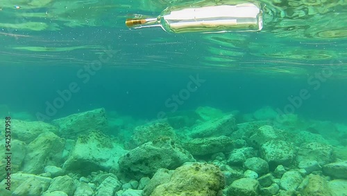 Message in a bottle. A message in a bottle floats on the surface of the sea. Bottle with message at sea