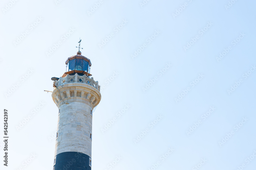 Lighthouse isolated on blue sky background. Hope or ambition concept photo