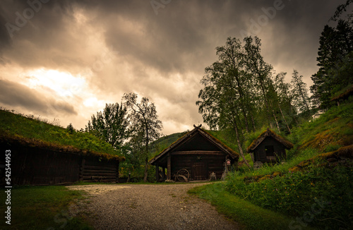 Cottage Architecture Anno 1580 With Farm House Carriage Wheel And Grindstone Next To Wooden Barn At Stalheim Folk Museum Near Stalheim Hotel In Vossestrand Norway.