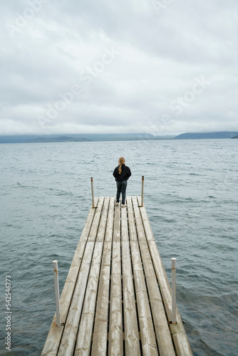 Girl admiring sea from pier