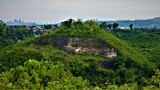 Beautiful view of a green hill with trees in the foreground in Cebu, Philippines