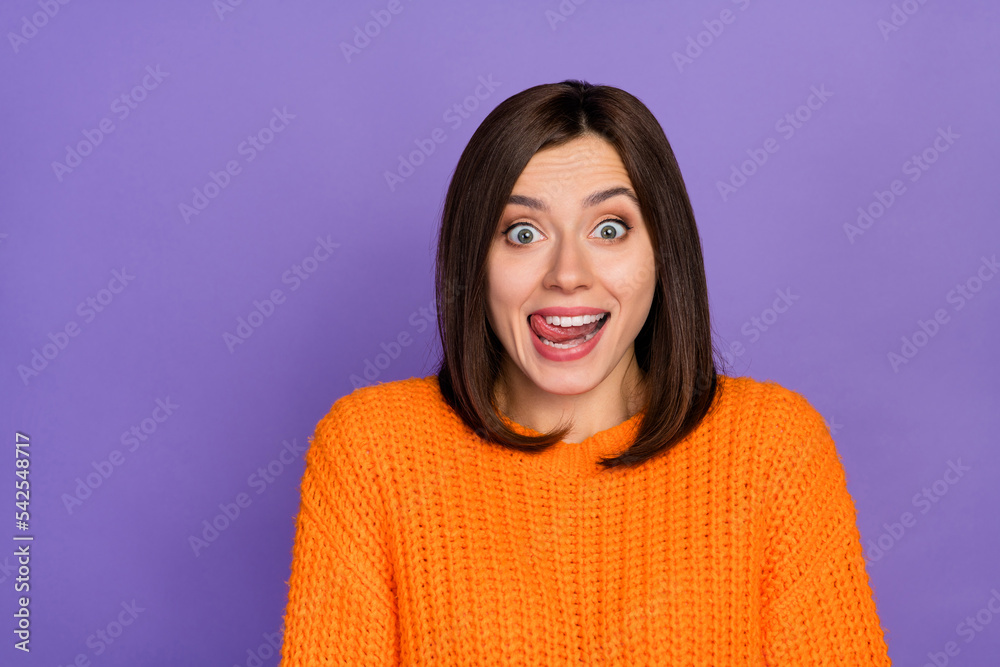 Photo portrait of stunning young lady excited lick lips cant wait eat wear trendy knitwear orange look isolated on violet color background Photo portrait of stunning young lady excited lick lips cant wait eat wear trendy knitwear orange look isolated on violet color background