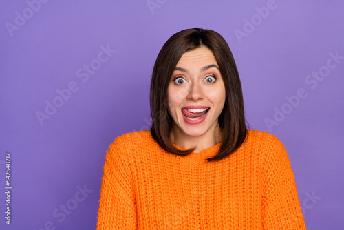 Photo portrait of stunning young lady excited lick lips cant wait eat wear trendy knitwear orange look isolated on violet color background