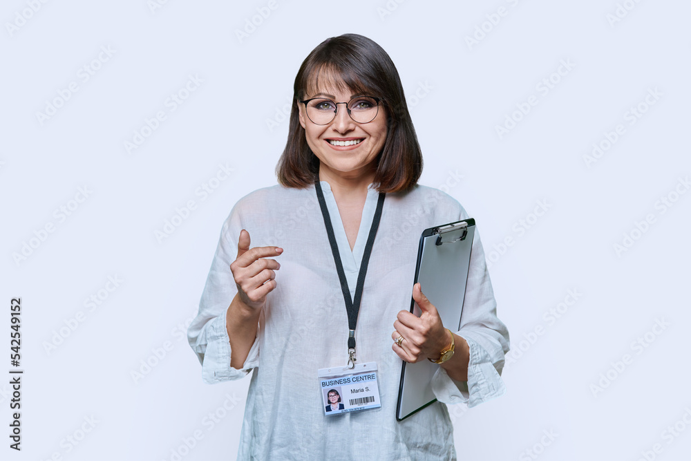 Portrait of woman with clipboard and name card, on white background Portrait of woman with clipboard and name card, on white background